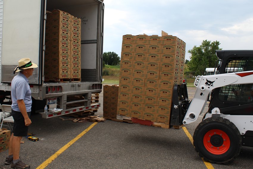 Volunteers for the Rotary Club of Golden unload peaches from Palisade-based Noland Orchards during the "Peaches for a Purpose" pickup Aug. 20 at Golden High School.